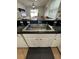 Close-up of a stainless steel kitchen sink with granite countertops, ideal for everyday use at 9959 Cypress Vine Dr, Orlando, FL 32827