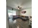 Cozy living area with hardwood floors, a large sectional sofa, and sliding glass doors to the backyard patio at 9959 Cypress Vine Dr, Orlando, FL 32827