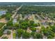 Aerial view of a residential area with houses nestled among green trees, offering a peaceful suburban setting at 1018 Featherstone Cir, Ocoee, FL 34761