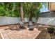 Brick patio with a fire pit, surrounded by a white fence, offering a cozy and inviting outdoor space at 1018 Featherstone Cir, Ocoee, FL 34761