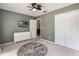 Comfortable bedroom with fresh paint, updated closet, and decorative area rug at 1018 Featherstone Cir, Ocoee, FL 34761