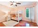 Cozy bedroom featuring a bunk bed, wood floors, and a soft area rug at 1018 Featherstone Cir, Ocoee, FL 34761
