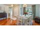 Bright dining room with hardwood floors, a large window, and views of the front yard at 1018 Featherstone Cir, Ocoee, FL 34761