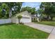 Well-maintained single-story home featuring an attached two-car garage and lush green lawn at 1018 Featherstone Cir, Ocoee, FL 34761