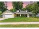 Charming single-story home with a manicured lawn, attached garage, and welcoming front porch at 1018 Featherstone Cir, Ocoee, FL 34761