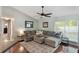 Comfortable living room featuring a large sectional sofa, stylish rug, and plenty of natural light at 1018 Featherstone Cir, Ocoee, FL 34761