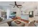 Inviting living room with mounted TV, hardwood floors, and sliding doors to outdoor patio at 1018 Featherstone Cir, Ocoee, FL 34761