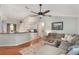 Spacious living room with a large sectional, hardwood floors, and an open layout to the kitchen at 1018 Featherstone Cir, Ocoee, FL 34761