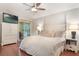 Relaxing primary bedroom features a king bed, hardwood floors, and sliding door access to the pool at 1018 Featherstone Cir, Ocoee, FL 34761