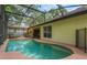 Outdoor pool inside of screened-in enclosure with safety fence, perfect for recreational fun at 1018 Featherstone Cir, Ocoee, FL 34761