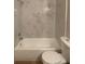 Bathroom showcasing a tub with marble-like tiling at 1071 S Hiawassee Rd # 1211, Orlando, FL 32835