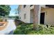 Well-maintained condo exterior with lush landscaping and a view of the lake at 1071 S Hiawassee Rd # 1211, Orlando, FL 32835