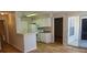 Modern kitchen boasts white cabinets and appliances, complemented by sleek countertops and light flooring at 1071 S Hiawassee Rd # 1211, Orlando, FL 32835