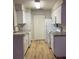 Efficient kitchen design with white appliances, cabinets, and ample storage at 1071 S Hiawassee Rd # 1211, Orlando, FL 32835