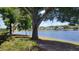 Lush lakeside view with mature shade trees and well manicured lawns near the lake at 1071 S Hiawassee Rd # 1211, Orlando, FL 32835
