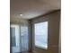 Bright living room featuring sliding glass doors and light-filtering blinds for natural light at 1071 S Hiawassee Rd # 1211, Orlando, FL 32835