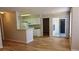 Open-concept living room with wood floors and ample natural light at 1071 S Hiawassee Rd # 1211, Orlando, FL 32835