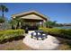 Community outdoor kitchen with grilling area and picnic table overlooking water at 1071 S Hiawassee Rd # 1211, Orlando, FL 32835