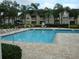 A view of the pool, chairs, and nearby apartment buildings at 1071 S Hiawassee Rd # 1211, Orlando, FL 32835