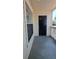 Cozy front porch featuring a black door and window, offering a welcoming entry to the property at 1071 S Hiawassee Rd # 1211, Orlando, FL 32835