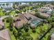 Aerial shot of private home featuring screen enclosed pool and spa, lush landscaping and terracotta-tiled roof at 11502 Waterstone Loop Dr, Windermere, FL 34786