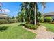 Manicured backyard features lush landscaping, a walkway, and lawn at 11502 Waterstone Loop Dr, Windermere, FL 34786