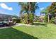Large landscaped backyard features a brick paver patio, a dining table, and a screened-in pool area at 11502 Waterstone Loop Dr, Windermere, FL 34786