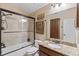 Bathroom featuring granite countertop, tile shower and a framed mirror at 11502 Waterstone Loop Dr, Windermere, FL 34786