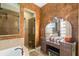 Elegant bathroom featuring a vanity with Hollywood lighting and a separate glass-enclosed shower at 11502 Waterstone Loop Dr, Windermere, FL 34786