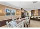 Bright dining area with modern chandelier, natural light, and views of the backyard at 11502 Waterstone Loop Dr, Windermere, FL 34786