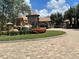 Gated community entrance featuring a stone waterfall, lush landscaping, and a guardhouse at 11502 Waterstone Loop Dr, Windermere, FL 34786