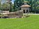 Community entrance featuring a stone monument with the neighborhood's name and a charming gazebo at 11502 Waterstone Loop Dr, Windermere, FL 34786