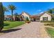 Beautiful single Gathering home with a well manicured lawn, charming details, and a paver driveway at 11502 Waterstone Loop Dr, Windermere, FL 34786