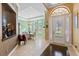 Bright foyer with mosaic wall decorations, an elegant front door, and views to the dining area at 11502 Waterstone Loop Dr, Windermere, FL 34786