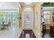 Bright foyer with decorative light fixture, an elegant front door, and views to the dining area at 11502 Waterstone Loop Dr, Windermere, FL 34786