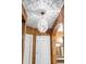Hallway featuring a modern chandelier, arched doorway, and view of the main bathroom at 11502 Waterstone Loop Dr, Windermere, FL 34786