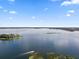 Vast expanse of a serene lake, highlighting a boat and the calm, reflective waters under a clear sky at 11502 Waterstone Loop Dr, Windermere, FL 34786