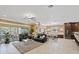 Open-concept living area with dining and kitchen, featuring comfortable seating and backyard views at 11502 Waterstone Loop Dr, Windermere, FL 34786