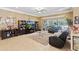 Comfortable living room featuring entertainment center and plush furniture overlooking backyard at 11502 Waterstone Loop Dr, Windermere, FL 34786