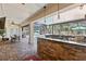 Covered outdoor kitchen overlooking the pool and screened lanai at 11502 Waterstone Loop Dr, Windermere, FL 34786