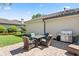 Back patio features outdoor dining table, a grill, and views of the landscaped yard at 11502 Waterstone Loop Dr, Windermere, FL 34786