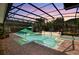 The screened pool area features a spa and lush landscaping at 11502 Waterstone Loop Dr, Windermere, FL 34786