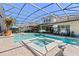Screened pool area features a spa, brick pavers, and lounge chairs in a beautifully landscaped yard at 11502 Waterstone Loop Dr, Windermere, FL 34786