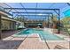 Relaxing screened-in pool and spa with brick paver decking, beautiful garden views and seating at 11502 Waterstone Loop Dr, Windermere, FL 34786