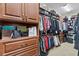 Walk-in closet with custom built-in shelving and hanging racks for optimal organization at 11502 Waterstone Loop Dr, Windermere, FL 34786