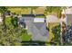 Aerial view of the home showcasing its roof, driveway, and lush green yard at 1202 Chichester St, Orlando, FL 32803