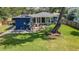 An aerial shot of a house in a big yard featuring a wooden deck, sunroom, and lush lawn at 1202 Chichester St, Orlando, FL 32803