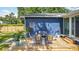 A beautiful back patio with blue house, decorated with nice outdoor seating and tropical plants at 1202 Chichester St, Orlando, FL 32803