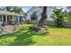 Lush backyard with healthy grass, a beautiful tree, and a nice outdoor seating area on the deck at 1202 Chichester St, Orlando, FL 32803