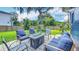 Outdoor patio with comfortable seating around a modern fire pit and a well-maintained lawn at 1202 Chichester St, Orlando, FL 32803